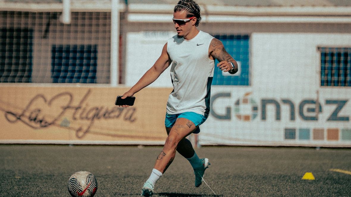 Alan back on the pitch, training with the ball